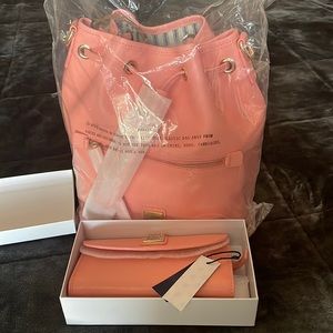 Dooney and Burke pale pink Draw string purse and matching wallet NEW.